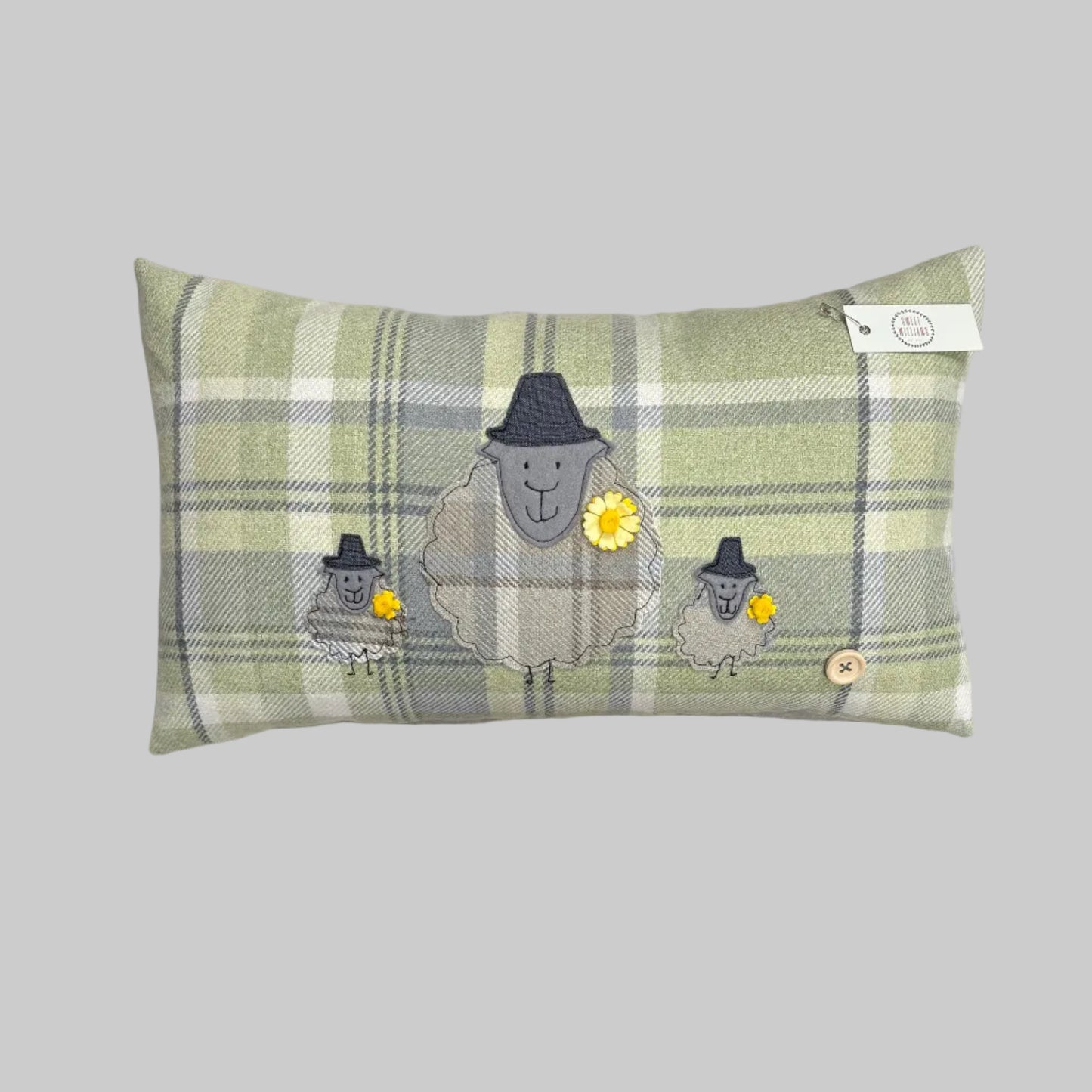 Green sheep cushion with lambs