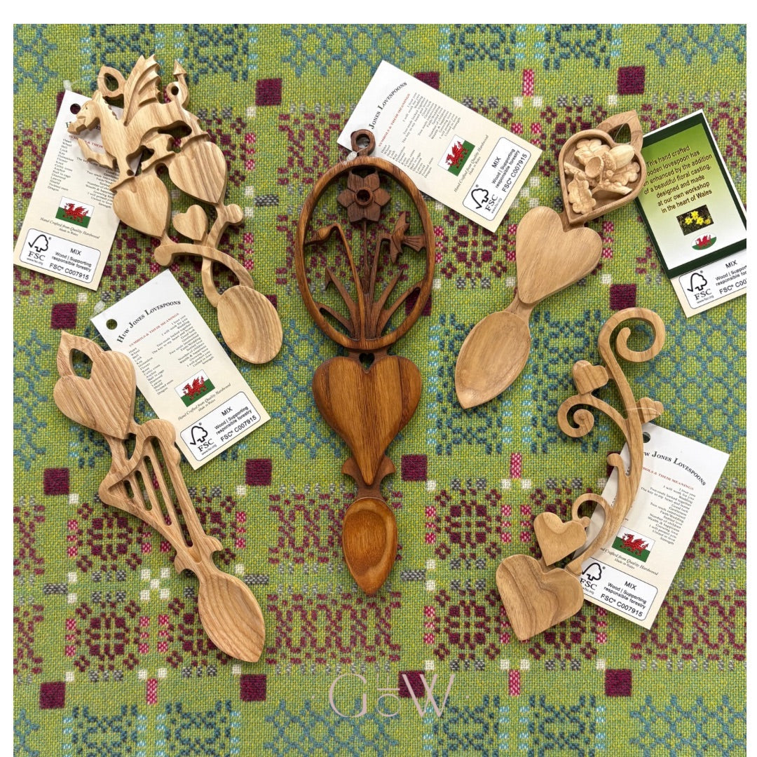A selection of traditional Welsh lovespoons on a traditional Welsh blanket