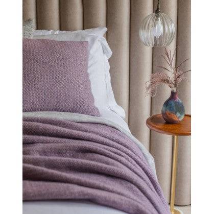 Lavender illusion pure new wool throw displayed on a bed